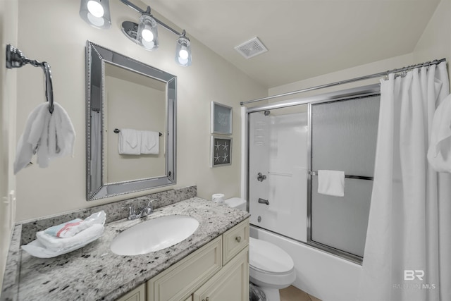 full bathroom featuring toilet, combined bath / shower with glass door, vanity, and visible vents