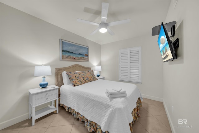 bedroom featuring light tile patterned floors, baseboards, and a ceiling fan