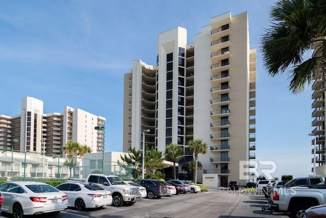 view of building exterior with uncovered parking