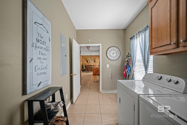 laundry area with light tile patterned flooring, cabinets, and washing machine and clothes dryer