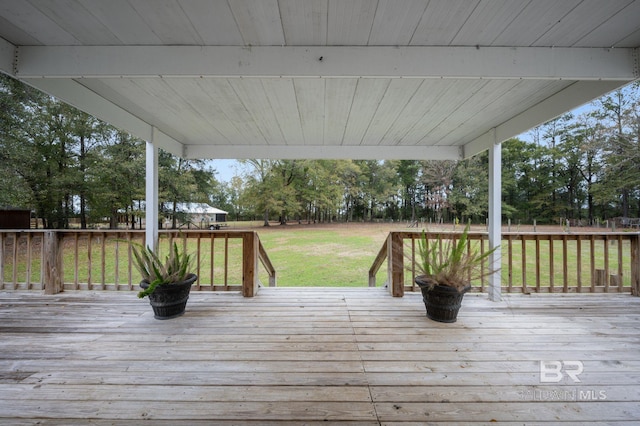 wooden deck with a lawn