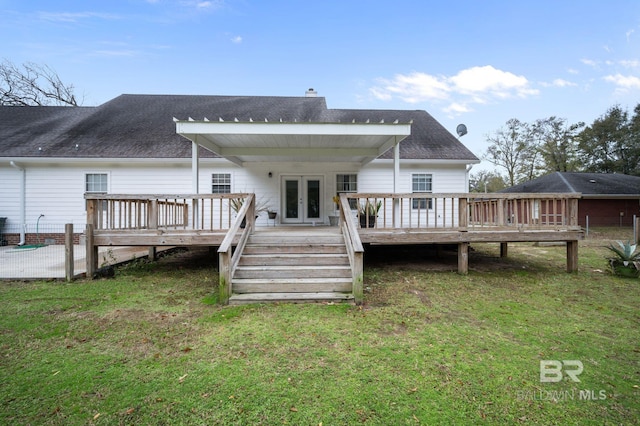 back of property featuring a lawn, a deck, and french doors