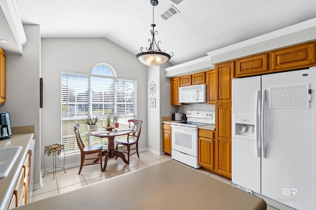 kitchen featuring pendant lighting, lofted ceiling, white appliances, sink, and light tile patterned flooring