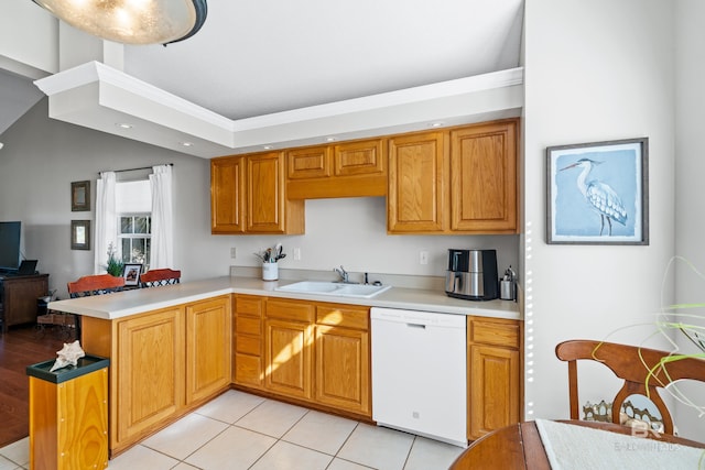 kitchen with kitchen peninsula, ornamental molding, white dishwasher, sink, and light tile patterned floors