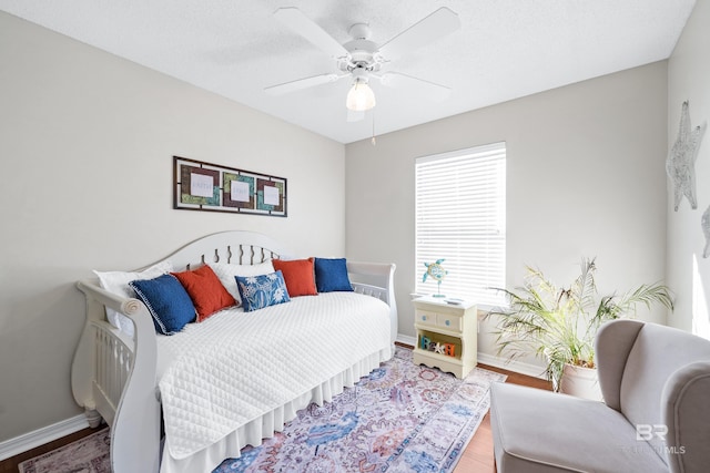 bedroom with wood-type flooring and ceiling fan