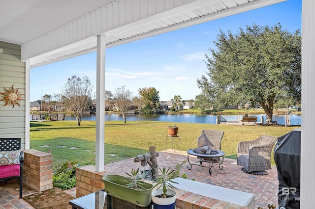 view of patio featuring a water view, area for grilling, and an outdoor fire pit