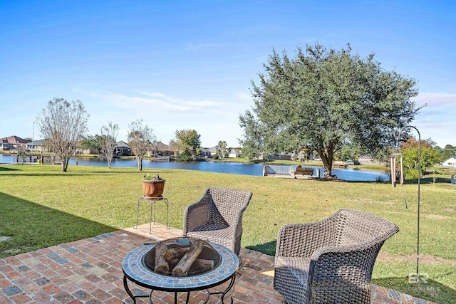 view of patio with a water view and an outdoor fire pit