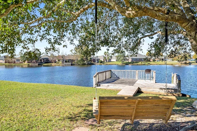 dock area featuring a yard and a water view