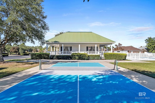 view of tennis court featuring basketball hoop