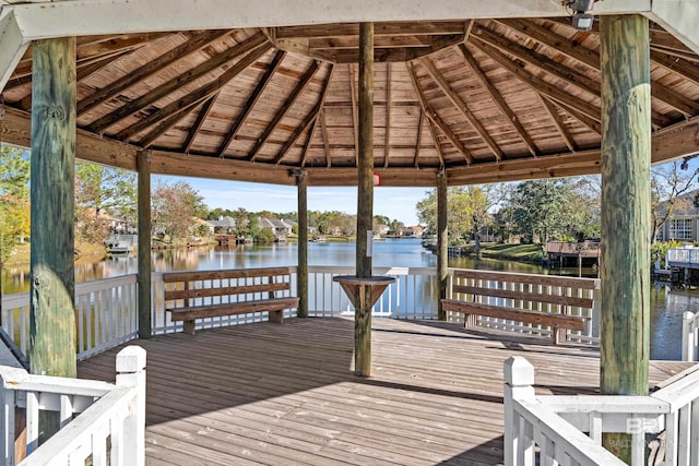 view of dock with a gazebo and a water view