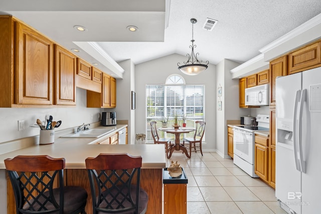 kitchen with kitchen peninsula, a breakfast bar, white appliances, sink, and pendant lighting