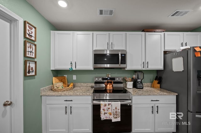 kitchen with visible vents, white cabinetry, and appliances with stainless steel finishes