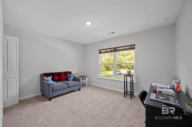 living area with visible vents, baseboards, and carpet