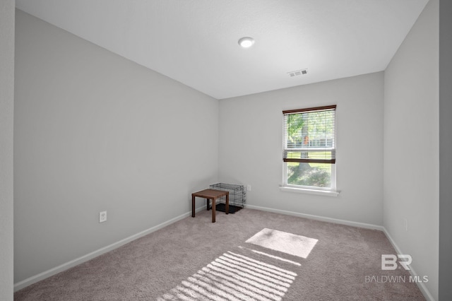 unfurnished room featuring visible vents, baseboards, and carpet floors