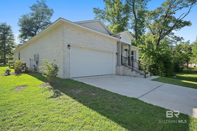 view of front of house with brick siding, driveway, an attached garage, and a front lawn