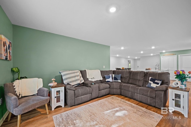 living room with recessed lighting and wood finished floors