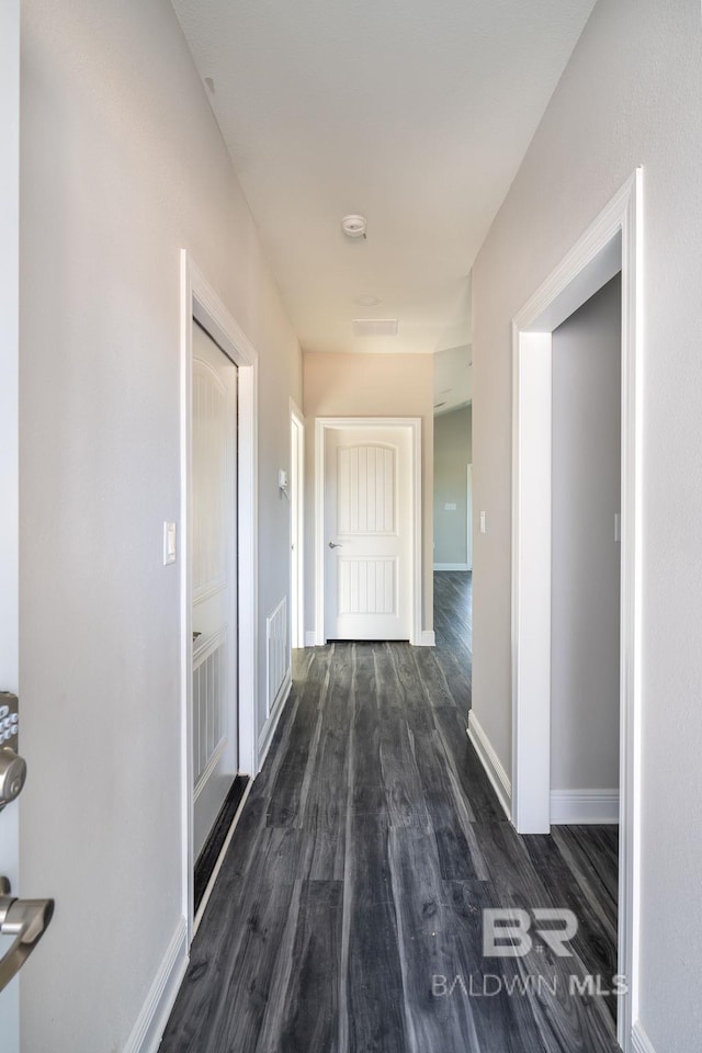 5241 Plateau Rd, Pensacola, FL 32507 - corridor featuring dark wood-type flooring and baseboards