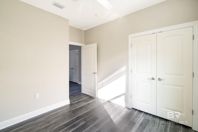 5241 Plateau Rd, Pensacola, FL 32507 - unfurnished bedroom with dark wood finished floors, a closet, baseboards, and a ceiling fan