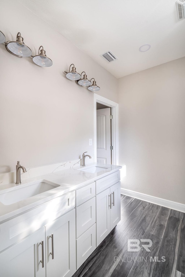 5241 Plateau Rd, Pensacola, FL 32507 - full bath featuring wood finished floors, baseboards, and double vanity