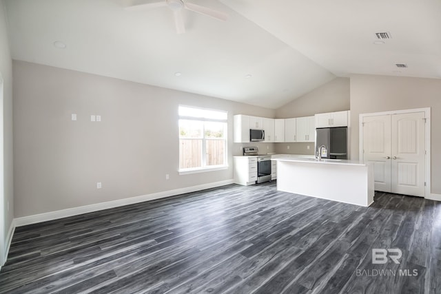 5241 Plateau Rd, Pensacola, FL 32507 - kitchen with stainless steel appliances, light countertops, white cabinetry, dark wood-style flooring, and an island with sink