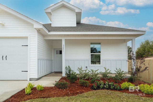 5241 Plateau Rd, Pensacola, FL 32507 - view of front of home with a porch, an attached garage, roof with shingles, board and batten siding, and fence