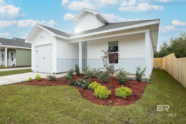 5241 Plateau Rd, Pensacola, FL 32507 - view of front facade featuring a garage, a shingled roof, driveway, and covered porch