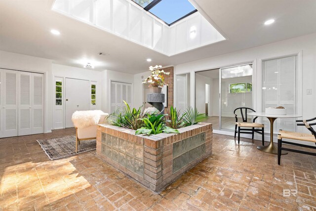 interior space with recessed lighting, a healthy amount of sunlight, and a skylight