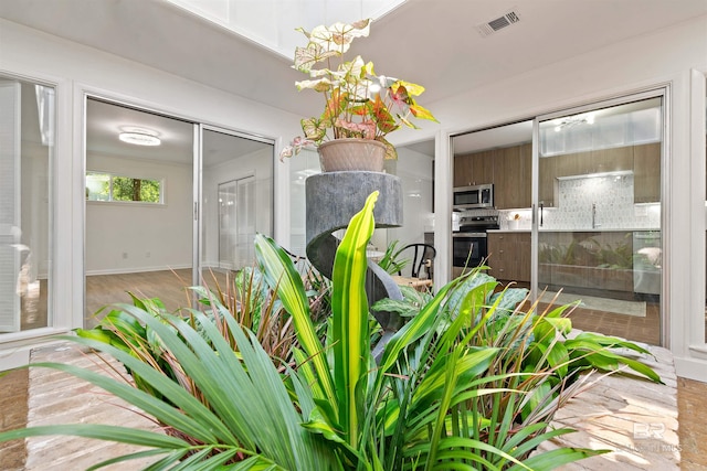 room details featuring appliances with stainless steel finishes, visible vents, and decorative backsplash