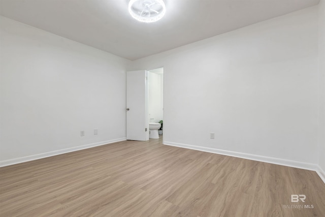 spare room with light wood-style flooring and baseboards