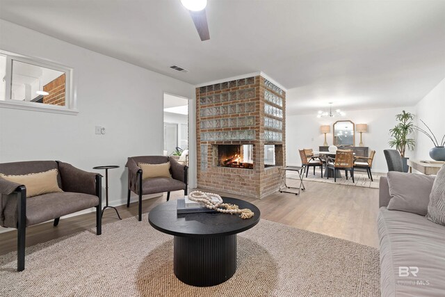 living room featuring light hardwood / wood-style flooring and ceiling fan