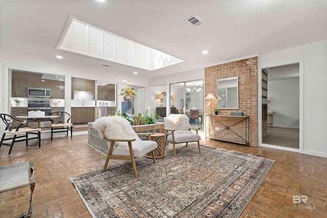 living area featuring brick floor, visible vents, and recessed lighting