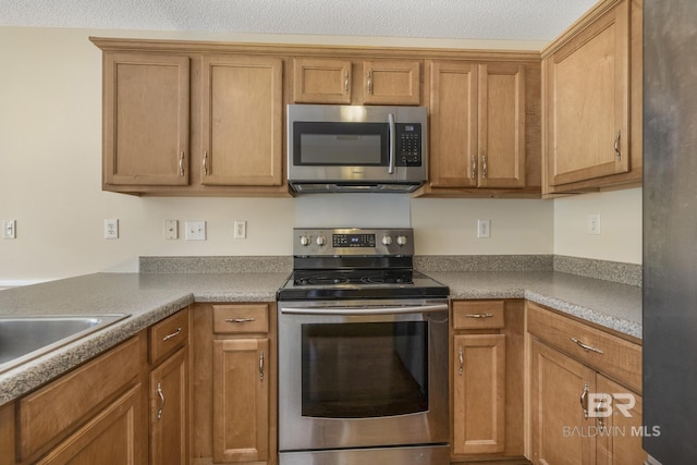 kitchen with stainless steel appliances, light countertops, and brown cabinets