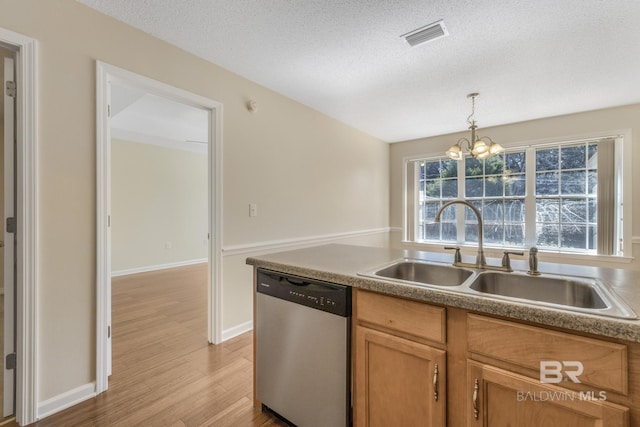 kitchen with visible vents, dishwasher, decorative light fixtures, light wood-type flooring, and a sink