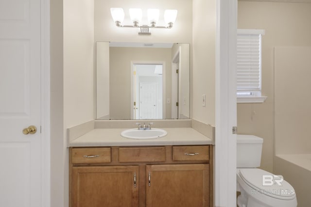 bathroom with a closet, vanity, and toilet