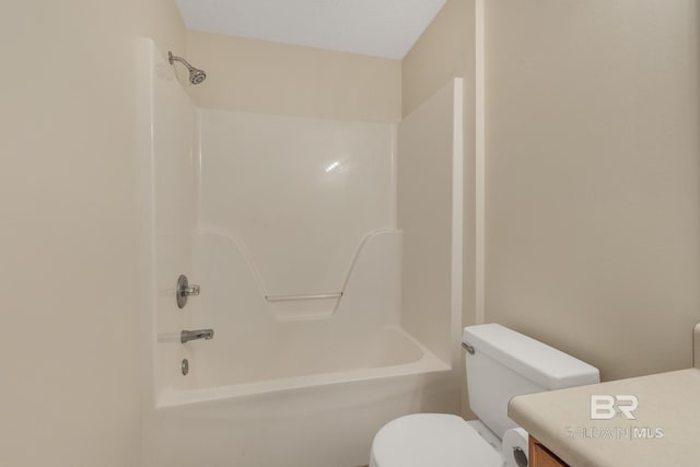 bathroom featuring toilet, shower / bathing tub combination, and vanity