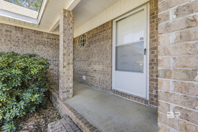 property entrance featuring brick siding