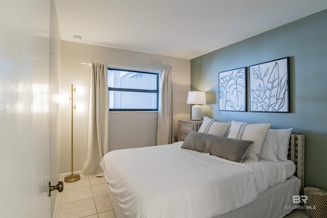 bedroom with light tile patterned floors