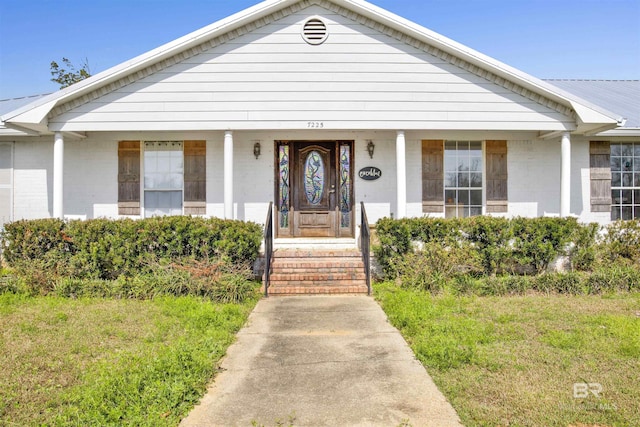 bungalow-style home with a front yard and a porch