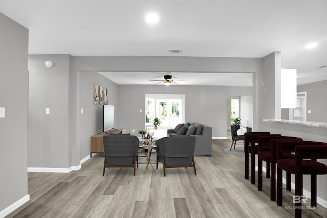 living room featuring ceiling fan and light wood-type flooring