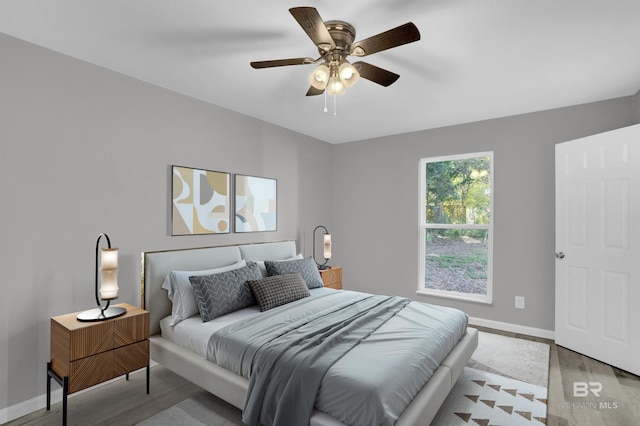 bedroom with ceiling fan and light hardwood / wood-style floors