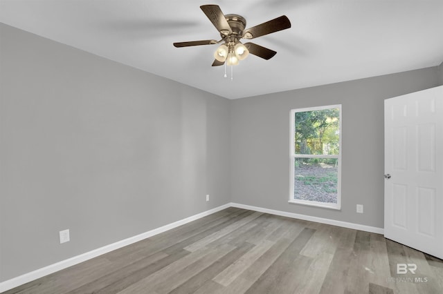 spare room with light wood-type flooring and ceiling fan