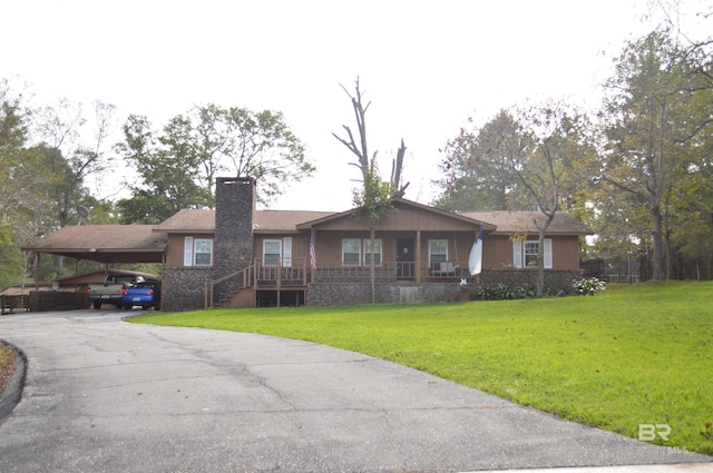 ranch-style home with a carport and a front yard