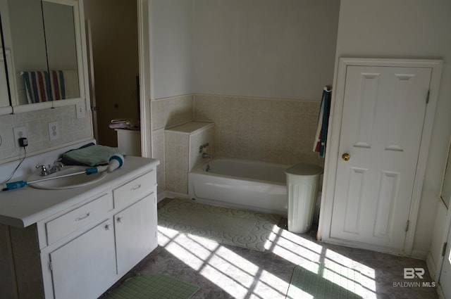 bathroom featuring tile patterned floors, a washtub, and vanity