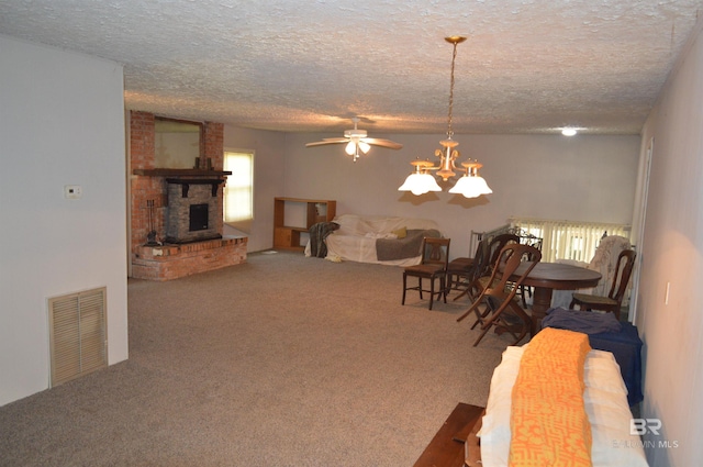 interior space featuring carpet, a textured ceiling, ceiling fan with notable chandelier, and a brick fireplace