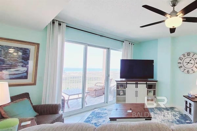 tiled living room with ceiling fan