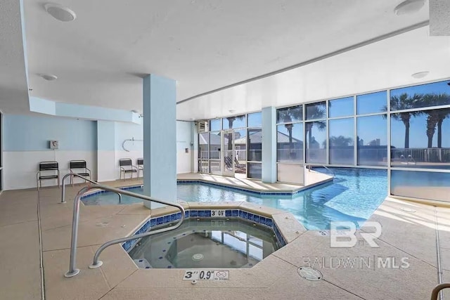 view of swimming pool with an indoor hot tub