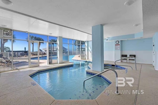 view of swimming pool with an indoor in ground hot tub