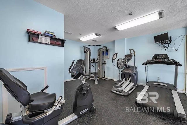 exercise room featuring a textured ceiling