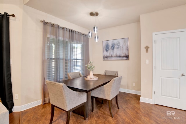 dining space with wood-type flooring