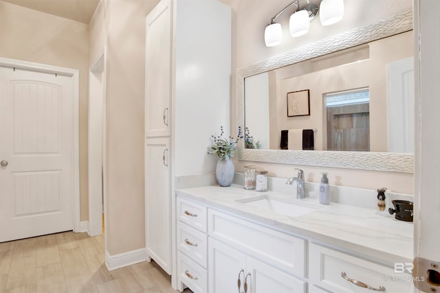 bathroom with vanity and hardwood / wood-style floors